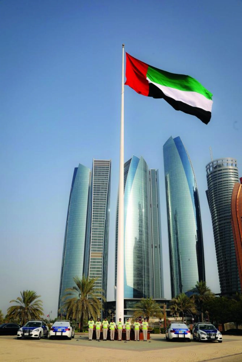 سيارات شرطة أبو ظبي تتزين بعلمي الإمارات والسعوية (واس)