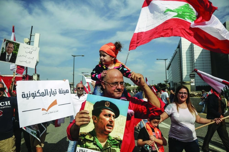 03 November 2019, Lebanon, Baabda: People gather with flags and banners near the Baabda Presidential Palace during a demonstration in support of Lebanese President Michel Aoun while the country prepares for immense protests demanding the change of the political structure. On 29 October 2019, Prime Minister Saad Hariri submitted his resignation, bowing to one of the protesters' key demand,
while sources close to Aoun reported that Hariri is likely to be renamed to head the new government. Photo: Marwan Naamani/dpa