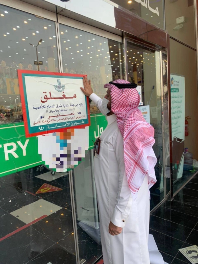مراقب خلال إغلاق أحد المحال المخالفة (مكة)