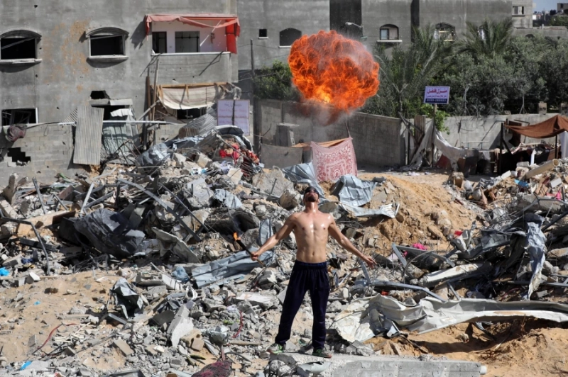 فلسطيني أمام بيت دمرته الغارات الاسرائيلية (مكة)