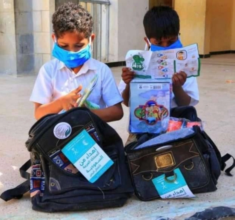 طفلان يحملان حقائب المركز (مكة)