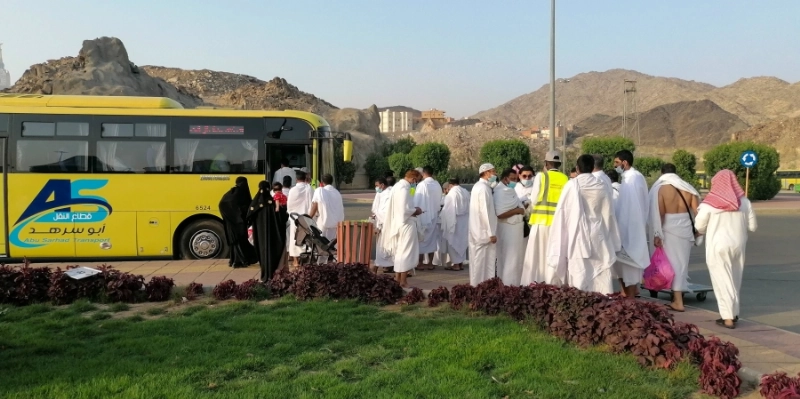 معتمرون في مواقف كدي ينتظرون باصات النقل إلى المسجد الحرام لأداء العمرة ومن ثم العودة إلى المواقف لاستقلال سياراتهم، في تنظيم يساعد
على فك الزحام.