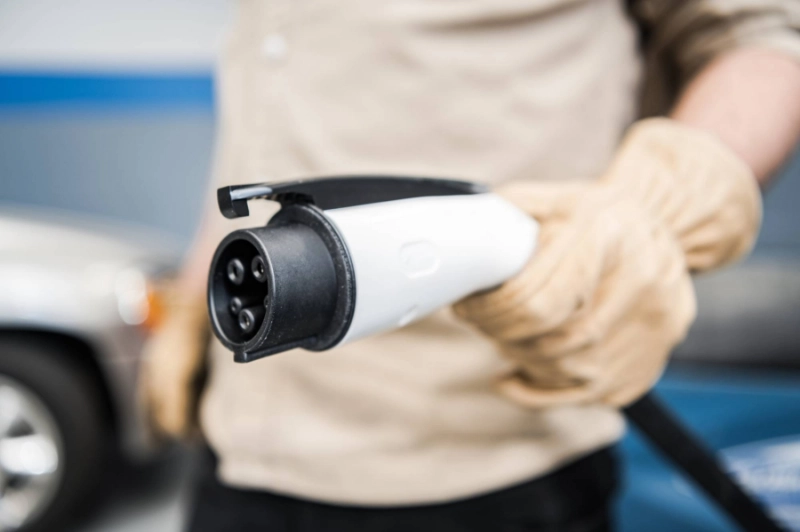 Electric Vehicle Smart Charger Plug in Mens Hand