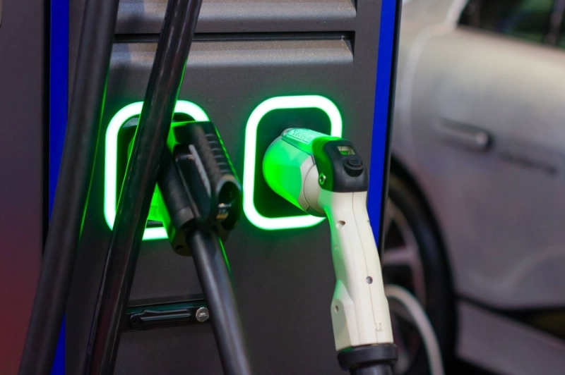 A modern electrical fast charger for the electrical or hybrid PHEV automobiles. An Energy power of future. Ecology friendly charger concept. Home electric car battery charger.