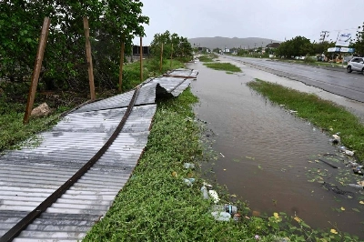 A blown down fence is seen in St. Catherine, Jamaica, on October 28, 2025. Ferocious winds and torrential rain tore into Jamaica Tuesday as Hurricane Melissa made landfall, the worst storm ever to strike the island nation and one of the most powerful hurricanes on record. The extremely violent Category 5 system was still crawling across the Caribbean, promising catastrophic floods and life-threatening conditions as maximum sustained winds reached a staggering 185 miles per hour (295 kilometers per hour). (AFP) A blown down fence is seen in St. Catherine, Jamaica, on October 28, 2025. Ferocious winds and torrential rain tore into Jamaica Tuesday as Hurricane Melissa made landfall, the worst storm ever to strike the island nation and one of the most powerful hurricanes on record. The extremely violent Category 5 system was still crawling across the Caribbean, promising catastrophic floods and life-threatening conditions as maximum sustained winds reached a staggering 185 miles per hour (295 kilometers per hour). (AFP)