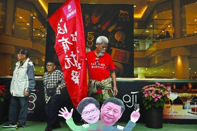 Koo Sze Yiu stands behind placards of Chinese President Xi Jinping and Hong Kong Chief Executive Carrie Lam during a protest before trying to board a ferry to Macau, in Hong Kong. (AFP/File photo) Koo Sze Yiu stands behind placards of Chinese President Xi Jinping and Hong Kong Chief Executive Carrie Lam during a protest before trying to board a ferry to Macau, in Hong Kong. (AFP/File photo)