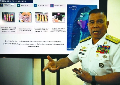 Philippine Navy spokesman Rear Admiral Roy Vincent Trinidad speaks next to a slide presentation of seized yellow bottles suspected to contain cyanide in waters of Second Thomas Shoal in the disputed South China Sea, during a press conference in Manila Monday. (AFP) Philippine Navy spokesman Rear Admiral Roy Vincent Trinidad speaks next to a slide presentation of seized yellow bottles suspected to contain cyanide in waters of Second Thomas Shoal in the disputed South China Sea, during a press conference in Manila Monday. (AFP)