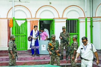 Security personnel and polling officials leave the home of an elderly voter after collecting their ballot through the home-voting process during the West Bengal Legislative Assembly elections in Kolkata Thursday. ( AFP) Security personnel and polling officials leave the home of an elderly voter after collecting their ballot through the home-voting process during the West Bengal Legislative Assembly elections in Kolkata Thursday. ( AFP)