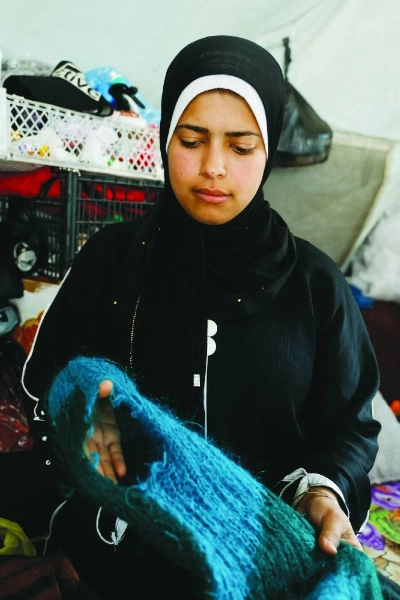 Palestinian bride-to-be Amani Abu Selmi holds damaged wool clothes inside a tent, after they were bitten by rodents, in Khan Younis in the southern Gaza Strip. – Reuters Palestinian bride-to-be Amani Abu Selmi holds damaged wool clothes inside a tent, after they were bitten by rodents, in Khan Younis in the southern Gaza Strip. – Reuters