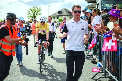 UAE Team Emirates-XRG’s Slovenian rider Tadej Pogacar wearing the overall leader’s yellow jersey is escorted to the podium after winning the fourth stage of the Tour of Romandie UCI cycling World tour. (AFP)
UAE Team Emirates-XRG’s Slovenian rider Tadej Pogacar wearing the overall leader’s yellow jersey is escorted to the podium after winning the fourth stage of the Tour of Romandie UCI cycling World tour. (AFP)