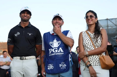 Aaron Rai of England and wife Gaurika Bishnoi look on alongside caddie Jason Timmis during the final round of the PGA Championship at Aronimink Golf Club in Newtown, Pennsylvania. (AFP) Aaron Rai of England and wife Gaurika Bishnoi look on alongside caddie Jason Timmis during the final round of the PGA Championship at Aronimink Golf Club in Newtown, Pennsylvania. (AFP)