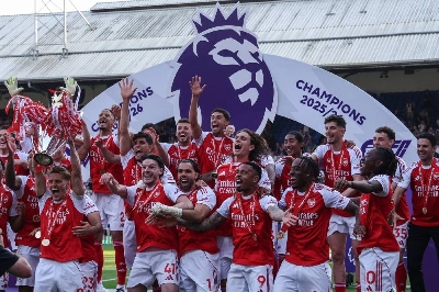 Arsenal's captain Martin Odegaard lifts the Premier League trophy as he celebrates with his teammates in London. (AFP) Arsenal's captain Martin Odegaard lifts the Premier League trophy as he celebrates with his teammates in London. (AFP)