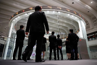 Visitors watch stock prices at the Tokyo Stock Exchange. The Nikkei 225 closed down 0.3% to 64,996.09 points yesterday. Visitors watch stock prices at the Tokyo Stock Exchange. The Nikkei 225 closed down 0.3% to 64,996.09 points yesterday.