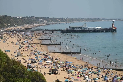 Sunbathers relax in the sunshine on Bournemouth beach on the south coast of England yesterday, as heatwave conditions spread to parts of southeast England and London. (AFP) Sunbathers relax in the sunshine on Bournemouth beach on the south coast of England yesterday, as heatwave conditions spread to parts of southeast England and London. (AFP)