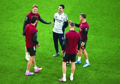 Arsenal's manager Mikel Arteta (centre) is all smiles as speaks with captain Martin Odegaard (left) and other players during a training session at the Puskas Arena in Budapest. (AFP) Arsenal's manager Mikel Arteta (centre) is all smiles as speaks with captain Martin Odegaard (left) and other players during a training session at the Puskas Arena in Budapest. (AFP)