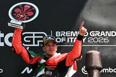 Team Aprilia Racing's Marco Bezzecchi celebrates on the podium with the trophy after winning the Italian Grand Prix at Mugello circuit, in Mugello, near Florence, on May 31, 2026. (AFP) Team Aprilia Racing's Marco Bezzecchi celebrates on the podium with the trophy after winning the Italian Grand Prix at Mugello circuit, in Mugello, near Florence, on May 31, 2026. (AFP)