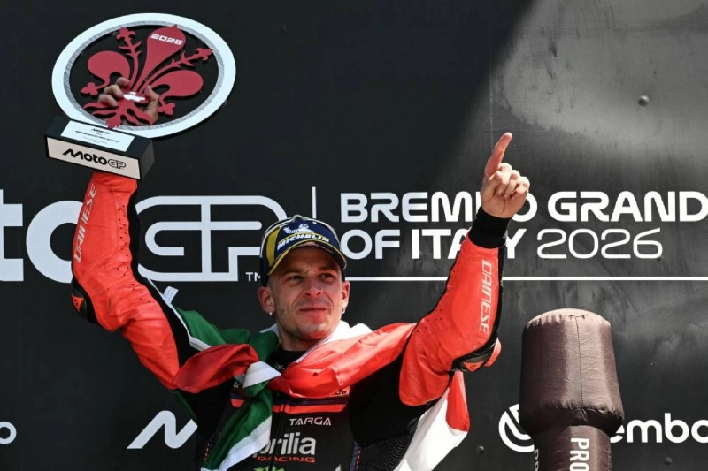 Team Aprilia Racing's Marco Bezzecchi celebrates on the podium with the trophy after winning the Italian Grand Prix at Mugello circuit, in Mugello, near Florence, on May 31, 2026. (AFP) Team Aprilia Racing's Marco Bezzecchi celebrates on the podium with the trophy after winning the Italian Grand Prix at Mugello circuit, in Mugello, near Florence, on May 31, 2026. (AFP)