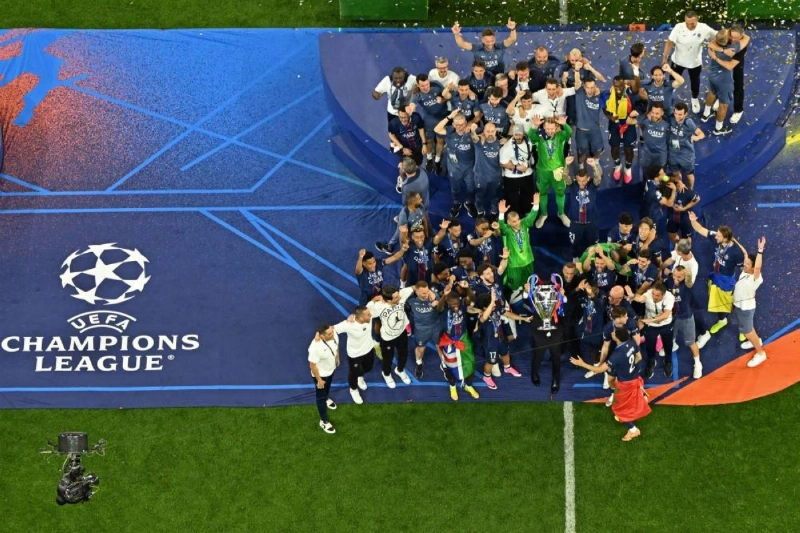 Paris Saint Germain's President Nasser al-Khelaifi lifts the trophy next to players after winning the UEFA Champions League final against Arsenal at the Puskas Arena in Budapest on May 30, 2026. (AFP) Paris Saint Germain's President Nasser al-Khelaifi lifts the trophy next to players after winning the UEFA Champions League final against Arsenal at the Puskas Arena in Budapest on May 30, 2026. (AFP)