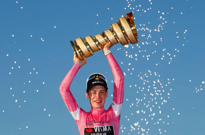 Team Visma Lease a Bike Danish rider Jonas Vingegaard wearing the overall leader's pink jersey holds the trophy as he celebrates on the podium after winning the Giro d'Italia 2026 - Tour of Italy cycling race between Rome and Rome, Italy, on May 31, 2026. (AFP) Team Visma Lease a Bike Danish rider Jonas Vingegaard wearing the overall leader's pink jersey holds the trophy as he celebrates on the podium after winning the Giro d'Italia 2026 - Tour of Italy cycling race between Rome and Rome, Italy, on May 31, 2026. (AFP)