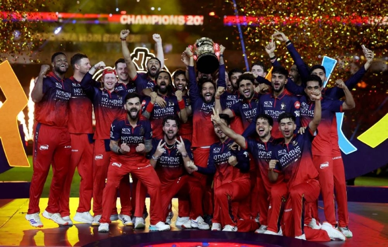 Royal Challengers Bengaluru's Rajat Patidar lifts the trophy as he celebrates with teammates after winning the Indian Premier League. (Reuters) Royal Challengers Bengaluru's Rajat Patidar lifts the trophy as he celebrates with teammates after winning the Indian Premier League. (Reuters)