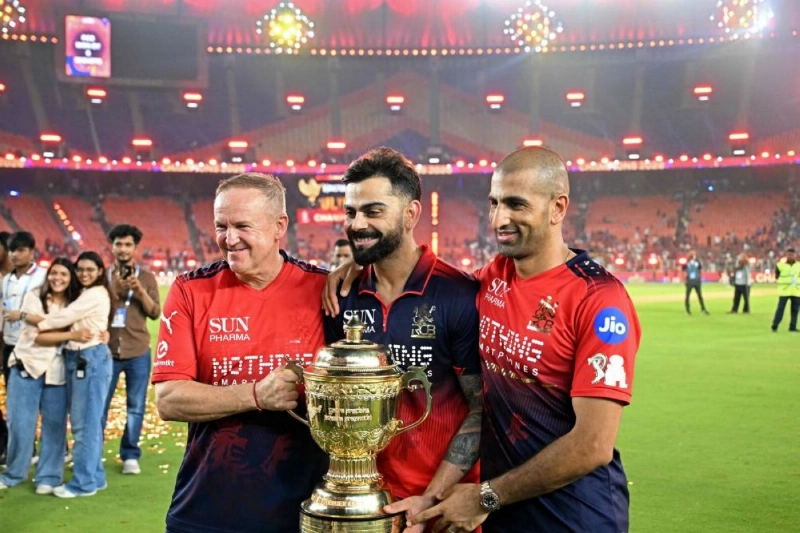 Royal Challengers Bengaluru's Virat Kohli (centre) and team head coach Zimbabwe's Andy Flower (left) celebrate with the trophy after their team's win against Gujarat Titans at the end of the 2026 Indian Premier League (IPL) T20 final match in Ahmedabad on June 1, 2026. (AFP) Royal Challengers Bengaluru's Virat Kohli (centre) and team head coach Zimbabwe's Andy Flower (left) celebrate with the trophy after their team's win against Gujarat Titans at the end of the 2026 Indian Premier League (IPL) T20 final match in Ahmedabad on June 1, 2026. (AFP)