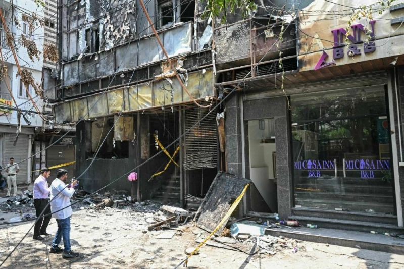 Forensics team members take photographs of the site following a fire that broke out at a hotel in New Delhi yesterday. (AFP) Forensics team members take photographs of the site following a fire that broke out at a hotel in New Delhi yesterday. (AFP)