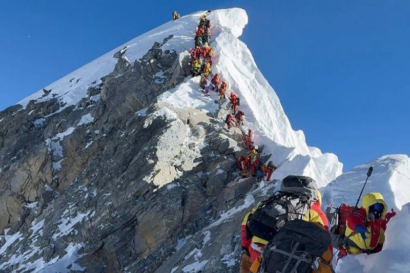 Mountaineers climbing a slope lined up during their ascent from the Hillary Step to summit Mount Everest in Nepal. (AFP) Mountaineers climbing a slope lined up during their ascent from the Hillary Step to summit Mount Everest in Nepal. (AFP)