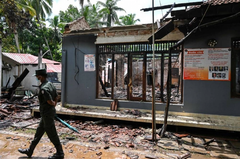 An army personnel walks past the burnt house in Sri Lanka's Batagoda yesterday, a day after a fire broke out at an elder care home. (AFP) An army personnel walks past the burnt house in Sri Lanka's Batagoda yesterday, a day after a fire broke out at an elder care home. (AFP)