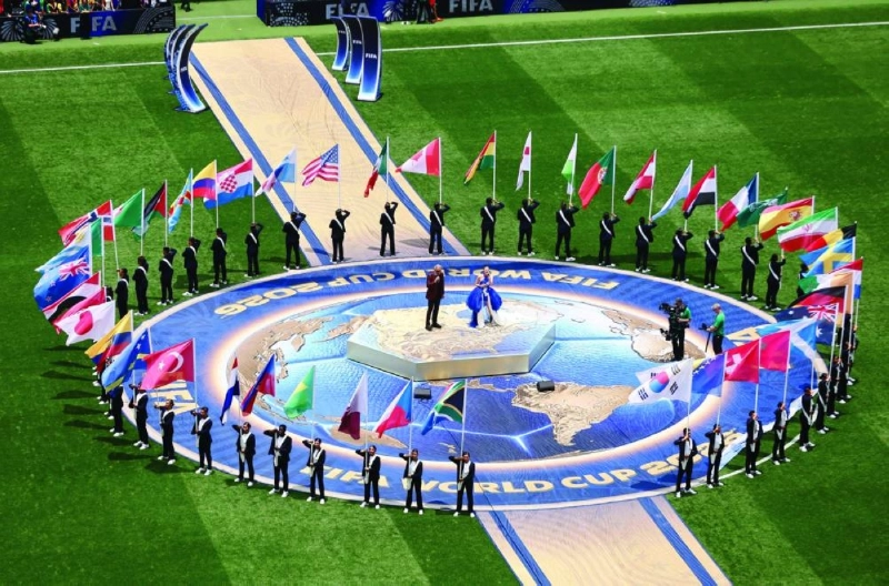 Italian singer Andrea Bocelli and South Korean-American singer Ejae perform as a parade of flags representing the 48 participating nations, including Qatar, is held by the volunteers.
Italian singer Andrea Bocelli and South Korean-American singer Ejae perform as a parade of flags representing the 48 participating nations, including Qatar, is held by the volunteers.