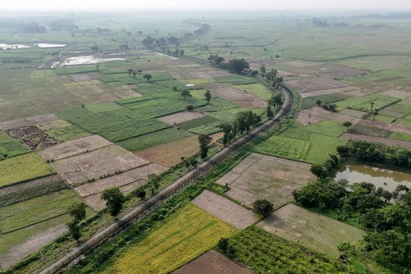 This aerial photograph shows agricultural fields on either side of the Benapole-Petrapole border crossing between Bangladesh (right) and India in Benapole. (AFP) This aerial photograph shows agricultural fields on either side of the Benapole-Petrapole border crossing between Bangladesh (right) and India in Benapole. (AFP)