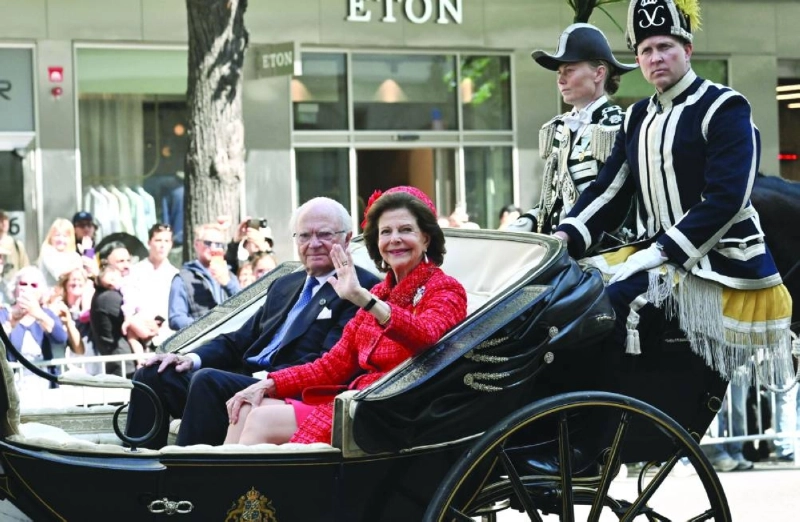 King Carl XVI Gustaf of Sweden and Queen Silvia of Sweden travel in a horse-drawn cortege through the streets of Stockholm during the royal couple's golden wedding anniversary Saturday. (AFP) King Carl XVI Gustaf of Sweden and Queen Silvia of Sweden travel in a horse-drawn cortege through the streets of Stockholm during the royal couple's golden wedding anniversary Saturday. (AFP)