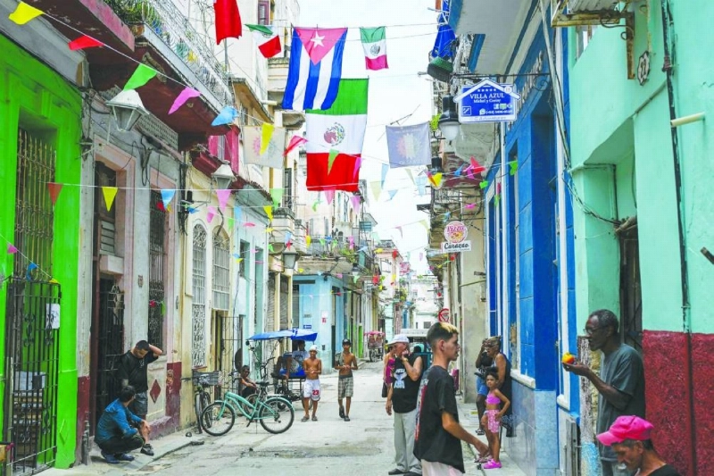 People are seen on a street decorated with flags of Mexico and Cuba in Havana on June 11, 2026, during the World Cup opening match between Mexico and South Africa. (AFP) People are seen on a street decorated with flags of Mexico and Cuba in Havana on June 11, 2026, during the World Cup opening match between Mexico and South Africa. (AFP)