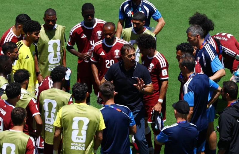 Qatar coach Julen Lopetegui gives instructions to players during a hydration break. Qatar coach Julen Lopetegui gives instructions to players during a hydration break.