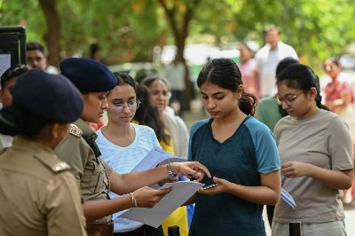 Police personnel check documents of medical students before NEET-UG re-examination in Ahmedabad on June 21, 2026. India's 2.2 million aspiring medical students sit a re-examination under tight security on June 21, after the last test was scrapped following a paper leak that triggered widespread outrage. (Photo by Shammi MEHRA / AFP) Police personnel check documents of medical students before NEET-UG re-examination in Ahmedabad on June 21, 2026. India's 2.2 million aspiring medical students sit a re-examination under tight security on June 21, after the last test was scrapped following a paper leak that triggered widespread outrage. (Photo by Shammi MEHRA / AFP)