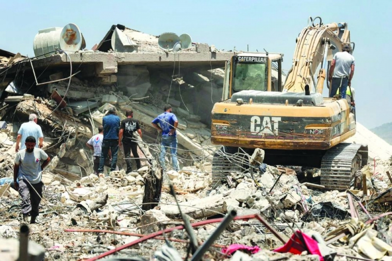 An excavator clears rubble from the site of a collapsed building, following Israeli bombardment in Nabatieh in southern Lebanon. (AFP)
An excavator clears rubble from the site of a collapsed building, following Israeli bombardment in Nabatieh in southern Lebanon. (AFP)