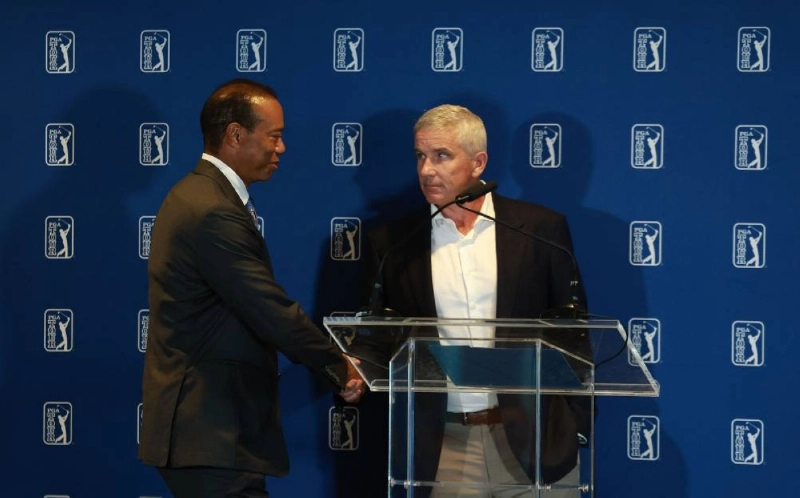 Tiger Woods of the US and Jay Monahan, Commissioner of the PGA TOUR, shake hands during a press conference with PGA TOUR CEO Brian Rolapp prior to the Travelers Championship 2026 at TPC River Highlands on June 23, 2026 in Cromwell, Connecticut. (AFP) Tiger Woods of the US and Jay Monahan, Commissioner of the PGA TOUR, shake hands during a press conference with PGA TOUR CEO Brian Rolapp prior to the Travelers Championship 2026 at TPC River Highlands on June 23, 2026 in Cromwell, Connecticut. (AFP)