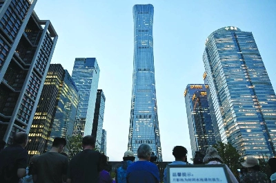 People gather near the CITIC Tower in Beijing on Friday, after an eyewitness reported plane debris at the base of Beijing's tallest building. (AFP) People gather near the CITIC Tower in Beijing on Friday, after an eyewitness reported plane debris at the base of Beijing's tallest building. (AFP)