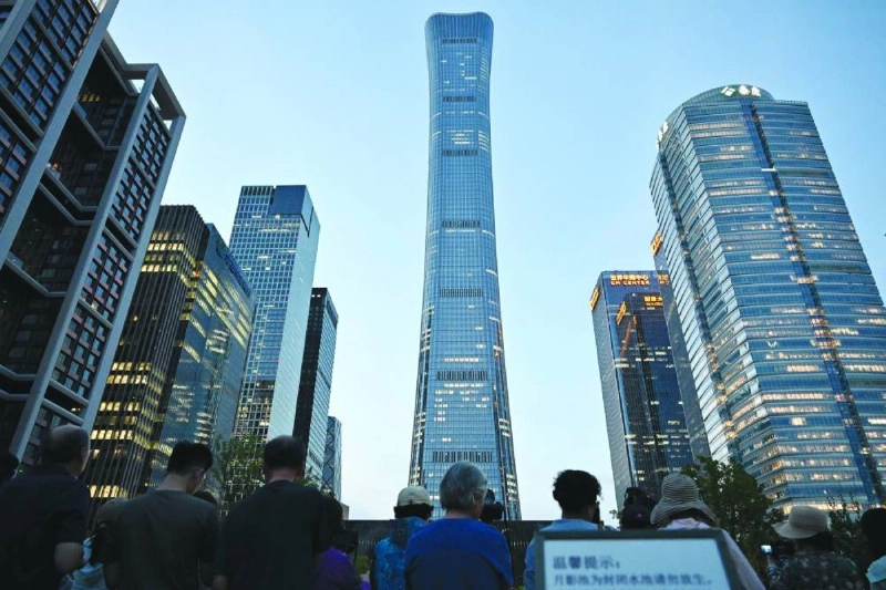 People gather near the CITIC Tower in Beijing on Friday, after an eyewitness reported plane debris at the base of Beijing's tallest building. (AFP) People gather near the CITIC Tower in Beijing on Friday, after an eyewitness reported plane debris at the base of Beijing's tallest building. (AFP)