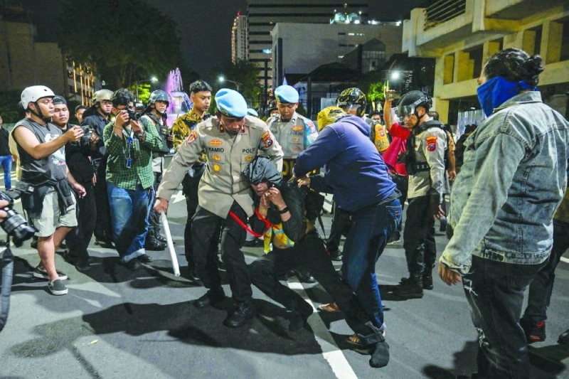 Indonesian police arrest a student following clashes during protest against a rise in non-subsidised fuel prices, inefficient government spending and military involvement in civilian affairs and the government's free school meals programme in Surabaya on Friday. ((AFP) Indonesian police arrest a student following clashes during protest against a rise in non-subsidised fuel prices, inefficient government spending and military involvement in civilian affairs and the government's free school meals programme in Surabaya on Friday. ((AFP)