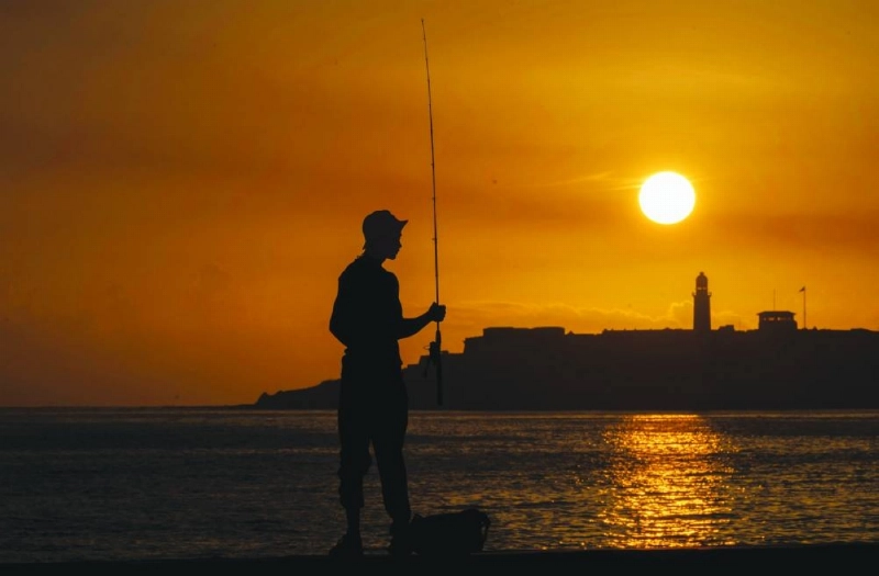 The silhouette of a fisherman is seen with the Morro lighthouse in the background during a power outage at dawn in Havana on June 29, 2026. (AFP) The silhouette of a fisherman is seen with the Morro lighthouse in the background during a power outage at dawn in Havana on June 29, 2026. (AFP)