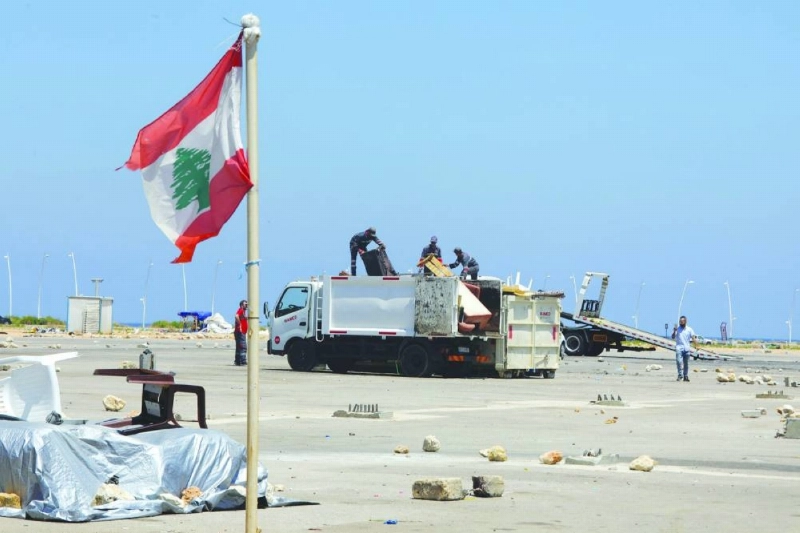 Workers load the dismantled tents onto a truck at the dispaced families’ camp along the waterfront area in Beirut on Wednesday. (AFP)
Workers load the dismantled tents onto a truck at the dispaced families’ camp along the waterfront area in Beirut on Wednesday. (AFP)