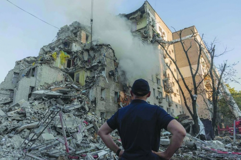 A man looks at a residential building damaged following a Russian air attack on the Ukrainian capital of Kyiv Thursday. (AFP) A man looks at a residential building damaged following a Russian air attack on the Ukrainian capital of Kyiv Thursday. (AFP)