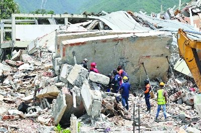 Rescuers work at the site of a collapsed building in Los Corales, Caraballeda, La Guaira state, Thursday. (AFP) Rescuers work at the site of a collapsed building in Los Corales, Caraballeda, La Guaira state, Thursday. (AFP)