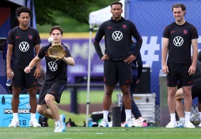 Brenden Aaronson of the United States catches a baseball as Tyler Adams, Auston Trusty and Joe Scally watch during a training session at Husky Soccer Stadium in Seattle. (AFP) Brenden Aaronson of the United States catches a baseball as Tyler Adams, Auston Trusty and Joe Scally watch during a training session at Husky Soccer Stadium in Seattle. (AFP)
