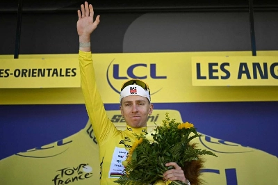 UAE Team Emirates-XRG's Slovenian rider Tadej Pogacar celebrates on the podium with the overall leader's yellow jersey after the 3rd stage of the 113th edition of the Tour de France, 196km between Granollers and Les Angles in southern France, on July 6, 2026. (AFP) UAE Team Emirates-XRG's Slovenian rider Tadej Pogacar celebrates on the podium with the overall leader's yellow jersey after the 3rd stage of the 113th edition of the Tour de France, 196km between Granollers and Les Angles in southern France, on July 6, 2026. (AFP)