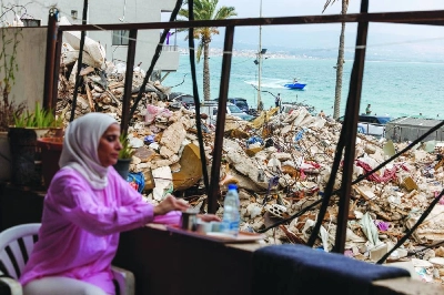 A woman sits at Tyre’s seafront promenade, near the rubble of a building destroyed in an Israeli strikes. (Reuters)
A woman sits at Tyre’s seafront promenade, near the rubble of a building destroyed in an Israeli strikes. (Reuters)