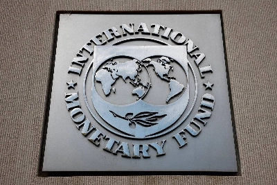 A view of the International Monetary Fund logo at its headquarters in Washington, DC. The IMF Wednesday inched its 2026 global growth forecast lower again to 3.0%, warning of ongoing risks posed by the war in the Middle East, trade fragmentation and potential corrections in market expectations for AI. A view of the International Monetary Fund logo at its headquarters in Washington, DC. The IMF Wednesday inched its 2026 global growth forecast lower again to 3.0%, warning of ongoing risks posed by the war in the Middle East, trade fragmentation and potential corrections in market expectations for AI.
