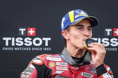 Ducati Lenovo Team's Spanish MotoGP rider Marc Marquez celebrates on the podium and kisses his medal after winning the Sprint race ahead of the MotoGP German motorcycle Grand Prix at the Sachsenring racing circuit, in Hohenstein-Ernstthal near Chemnitz, eastern Germany on July 11, 2026. (AFP) Ducati Lenovo Team's Spanish MotoGP rider Marc Marquez celebrates on the podium and kisses his medal after winning the Sprint race ahead of the MotoGP German motorcycle Grand Prix at the Sachsenring racing circuit, in Hohenstein-Ernstthal near Chemnitz, eastern Germany on July 11, 2026. (AFP)