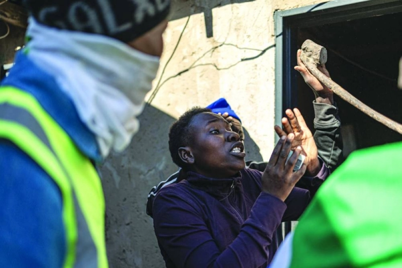 TOPSHOT - South African residents hold an ID card as they gesture to protect themselves during an anti-migrant protest in Alexandra near Johannesburg on July 16, 2026. Protest organisers and participants have vowed to continue holding demonstrations every Thursday as part of an ongoing anti-migrant campaign. (Photo by EMMANUEL CROSET / AFP) TOPSHOT - South African residents hold an ID card as they gesture to protect themselves during an anti-migrant protest in Alexandra near Johannesburg on July 16, 2026. Protest organisers and participants have vowed to continue holding demonstrations every Thursday as part of an ongoing anti-migrant campaign. (Photo by EMMANUEL CROSET / AFP)