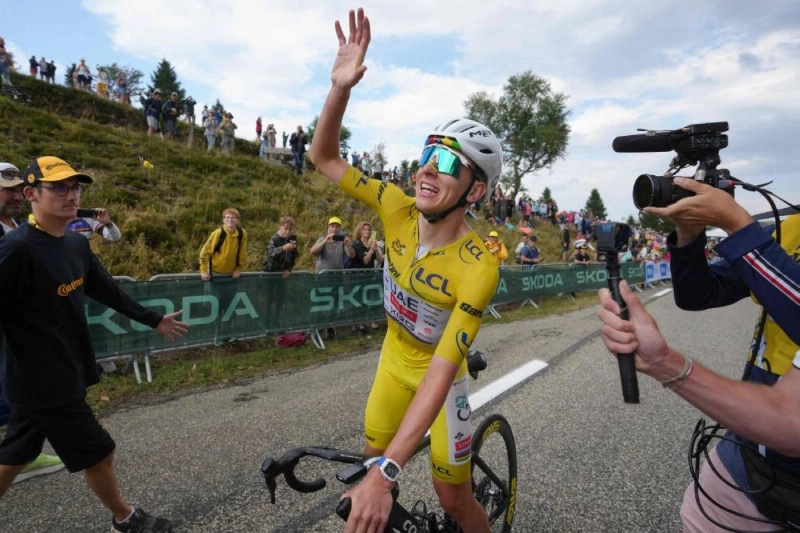 UAE Team Emirates - XRG's Slovenian rider Tadej Pogacar wearing the overall leader's yellow jersey celebrates after winning the 14th stage of the 113th edition of the Tour de France, 155 km between Mulhouse and Le Markstein in the Vosges mountains, on July 18, 2026. (AFP) UAE Team Emirates - XRG's Slovenian rider Tadej Pogacar wearing the overall leader's yellow jersey celebrates after winning the 14th stage of the 113th edition of the Tour de France, 155 km between Mulhouse and Le Markstein in the Vosges mountains, on July 18, 2026. (AFP)